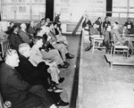 A group of fourteen American clergymen (left) attend the trial of former camp personnel and prisoners from Buchenwald during their tour of camp sites in 1947.