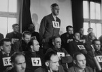 August Eigruber, former Gauleiter of Upper Austria, and a defendant at the trial of 61 former camp personnel and prisoners from Mauthausen, stands in his place in the defendants' dock.