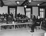 Father Johann Nehausler, former counselor to the Bishop Cardinal of Munich and a former inmate of Dachau, testifies at the trial of former camp personnel and prisoners from Dachau.