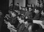 The defendants receive the indictments against them at the trial of 61 former camp personnel and prisoners from Mauthausen.