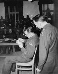 Capt. John Barnett testifies to the authenticity of photos taken when his troops overran the Dachau concentration camp at the trial of former camp personnel and prisoners from Dachau.