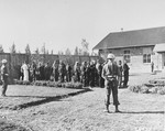 The 31 former camp personnel and prisoners on trial for crimes committed at Buchenwald wait in the courtyard by the courtroom on the day they are to be sentenced.