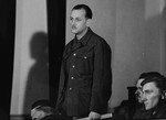 Defendant Gustav Kreindl, at the trial of 61 former camp personnel and prisoners from Mauthausen, stands in his place in the defendants' dock.