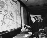 Defendant Josef Kestel indicates on a map where he shot a prisoner trying to escape, during the trial of former camp personnel and prisoners from Buchenwald.