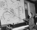 Mr. Blank, a German civilian, identifies the spot on a diagram of the camp where he saw Russian prisoners of war being taken away to be shot.