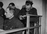 An unidentified defendant at the trial of 61 former camp personnel and prisoners from Mauthausen, sits in his place in the defendants' dock.
