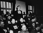 Former SS-Unterscharfuehrer Andreas Trumm, a defendant at the trial of 61 former camp personnel and prisoners from Mauthausen, stands in his place in the defendants' dock.