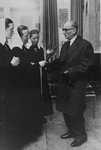 Dr. Otto Wolken receives flowers from a group of nuns, probably before testifying at the Frankfurt Auschwitz trial.