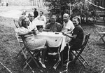 A group of friends play cards outside.

Pictured on the left are Rudolf and Dora Friedmann.