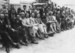 Jewish officials of the Vilna ghetto are seated in the audience at a sporting event.