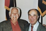 Portrait of American liberator Arnold E. Samuelson (left) and survivor George Havas (right) in front of the liberator flags at the U.S.