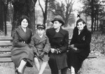 A Jewish boy, Wilhelm Beigel, poses with his aunt and uncle on a park bench in Vilna.