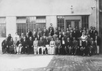 Lajos and Ferenc Fenyves pose with the staff of their printing plant.
