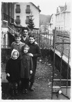 Gerhard Mahler poses with the children of a family in La Bourboule who hosted his bar mitzvah.