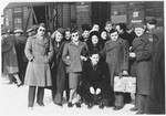 Wilhelm Beigel (kneeling in front) poses with HIAS workers at the Munich train station prior to his departure for the U.S.