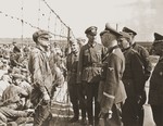 Reichsfuehrer-SS Heinrich Himmler and his entourage visit a POW camp while on a tour of the Eastern Front.