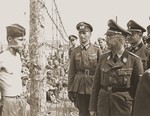 Heinrich Himmler looks at a young Soviet prisoner during an official visit to a POW camp in the vicinity of Minsk.