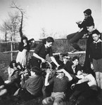 Jewish refugee teenagers enjoy a snack on the grounds of the Chateau de Chabannes OSE [Oeuvre de Secours aux Enfants] children's home.