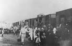 Jews from the Warsaw ghetto board a deportation train with the assistance of Jewish police.