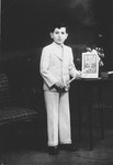 Studio portrait of a Jewish boy holding a Torah pointer [probably at his Bar Mitzvah].