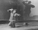 Aleksander Kulisiewicz, dressed in a concentration camp uniform, performs "Muselman" at the Theater Communale in Bologna, Italy.