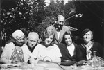 Simon and Evy Brod (second and third from the left) dine outside with friends.