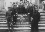 Students in a leatherworking class pose outside on the steps of the Chabannes children's home.