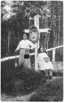 Emilie (Geromin) Bordin poses with her daughter Sofie and son Rudolf at the grave of two of her other children in Tobolsk, Siberia.
