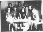 A group of Jewish DPs gather around a table in Koeslin, Poland.