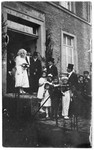 Bertha Steinberger and Siegmund Marx leave the synagogue after their wedding ceremony, accompanied by a group of small children.