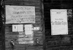 Notices posted on the wall of a barracks at the Neu Freimann displaced persons camp.