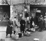 Polish women wait in line for bread in postwar Warsaw.