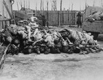 An American soldier photographs a pile of corpses in the newly liberated Buchenwald concentration camp.