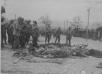 American soldiers view the bodies of prisoners shot by the SS during the evacuation of the Ohrdruf concentration camp.