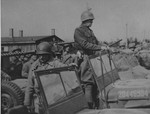 General George Patton (standing in the jeep) prepares to depart from Ohrdruf after an official tour of the newly liberated camp.