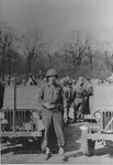 American liberator Fred Mercer poses in front of a jeep in Ohrdruf during General Dwight Eisenhower's inspection tour of the newly liberated concentration camp.