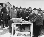 Survivors of the Ohrdruf concentration camp demonstrate torture methods used in the camp to top ranking American generals.