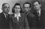 Group portrait of four survivors, who were living as displaced persons in Germany.