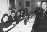 Jewish displaced persons recite the marriage blessings for the bride and groom at a Sheva Brachot (post-nuptial) wedding celebration.