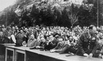 American and German officials participate at an outdoor meeting of Jewish DPs in the American Zone of Germany held in the Mittenwald displaced persons camp to commemorate the death march from Dachau to Tyrol.