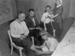 Displaced persons awaiting repatriation are cared for by Russian nurses at the infirmary of a DP camp in Goeppingen.