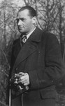 Portrait of Mendel Rozenblit holding a camera while living as a displaced person in Munich.