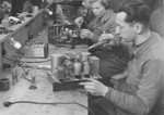 A group of men builds radios in an ORT (Organization for Rehabilitation through Training) training workshop in the Landsberg displaced persons' camp.