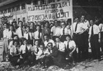 Jewish musicians and actors in the Feldafing displaced persons camp pose beneath a Yiddish banner that reads: "The blood of the victims of fascism calls for vigilance."

Among those pictured is Leybl Fingerhut (front row in sunglasses).