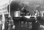 A speaker addresses an outdoor assembly of Jewish DPs held in the Mittenwald displaced persons camp to protest British immigration policy in Palestine and to commemorate the death march from Dachau to Tyrol.