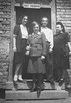 Jewish DPs pose with an ORT representative at the entrance to a workshop in the Feldafing displaced persons camp.