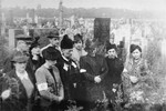 Ghetto residents attend a memorial service for a relative at the Jewish cemetery in Warsaw.