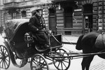 A hansom cab and its driver in Warsaw.