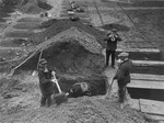 German civilians exhume the bodies of 44 Polish and Russian forced laborers who were put to death at the Hadamar Institute and buried in a mass grave behind the euthanasia facility.