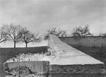 View of the wall surrounding the cemetery of the Hadamar Institute on which jagged pieces of glass were placed to discourage observers.